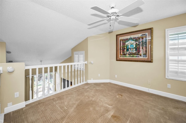 bonus room featuring carpet, ceiling fan, a wealth of natural light, and vaulted ceiling