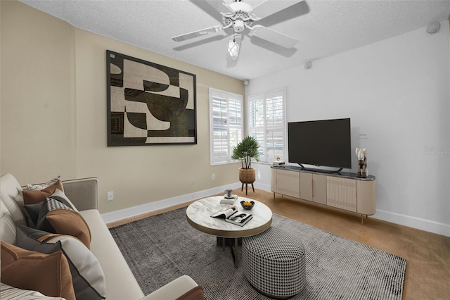 carpeted living room with a textured ceiling and ceiling fan