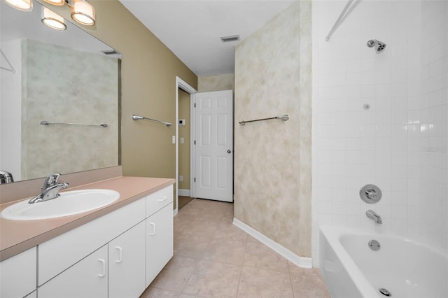 bathroom with tile patterned floors, tiled shower / bath combo, and vanity