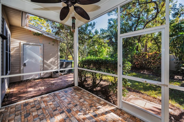 unfurnished sunroom with plenty of natural light and ceiling fan