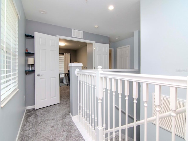 hallway featuring light carpet