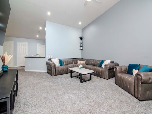 living room featuring ceiling fan, light colored carpet, and lofted ceiling