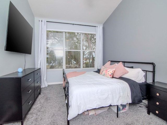 carpeted bedroom featuring vaulted ceiling