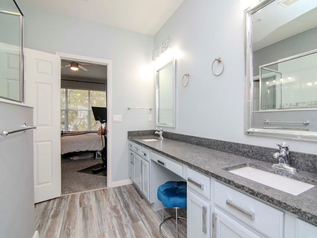 bathroom featuring vanity, hardwood / wood-style flooring, and ceiling fan