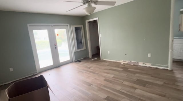 unfurnished room featuring ceiling fan, wood-type flooring, and french doors