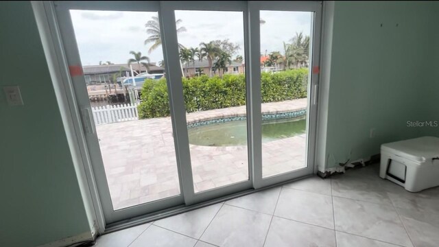 doorway with light tile patterned floors