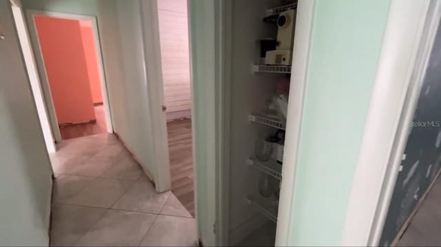 hallway with light tile patterned floors