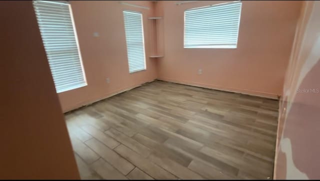 unfurnished room with light hardwood / wood-style flooring