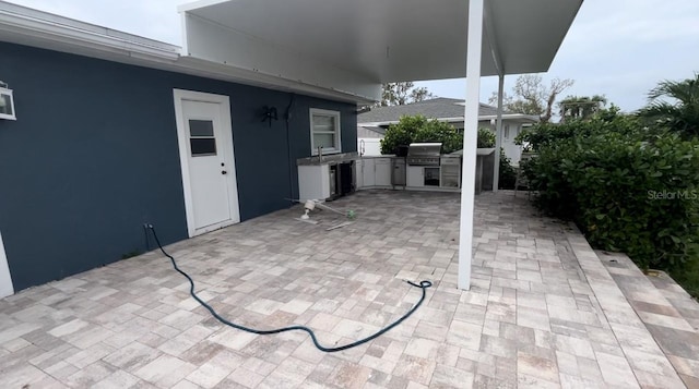 view of patio / terrace featuring area for grilling and sink