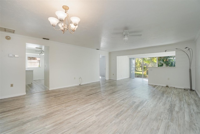 unfurnished living room with ceiling fan with notable chandelier, light hardwood / wood-style flooring, and ornamental molding