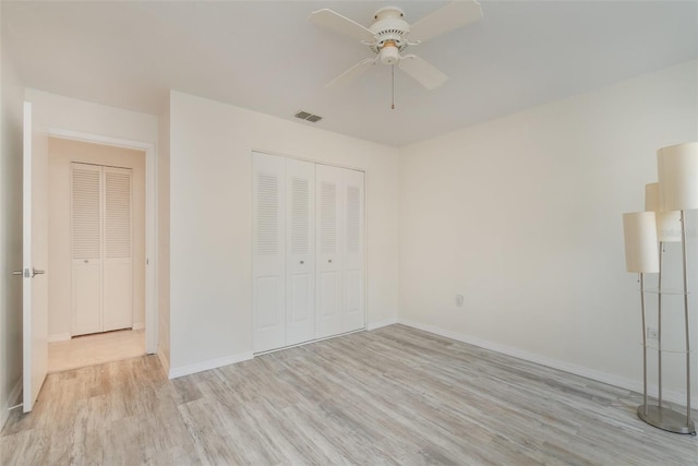 unfurnished bedroom featuring ceiling fan, a closet, and light hardwood / wood-style floors