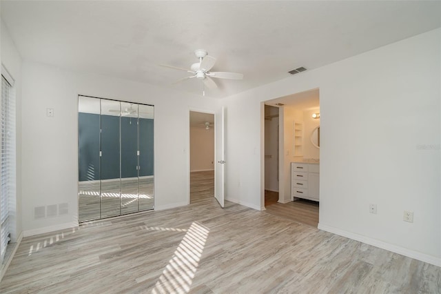 unfurnished room with ceiling fan and light hardwood / wood-style floors