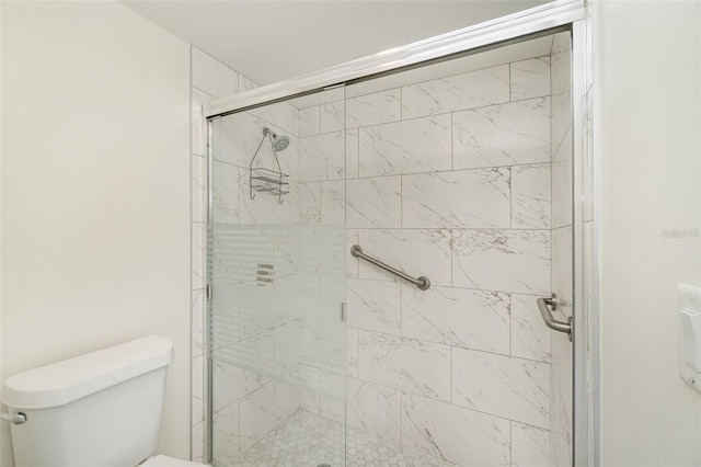 bathroom with toilet and an enclosed shower