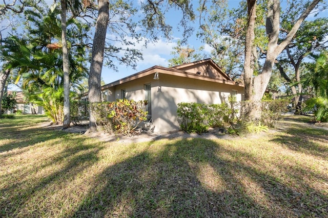 view of side of home featuring a yard