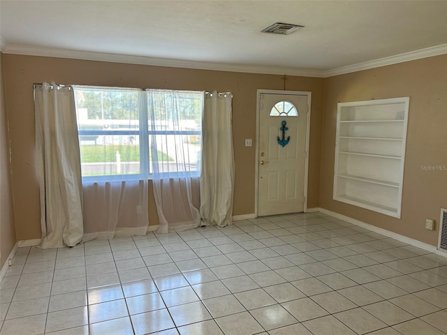 entrance foyer with light tile patterned floors and ornamental molding