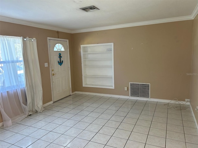 entryway with light tile patterned floors and ornamental molding