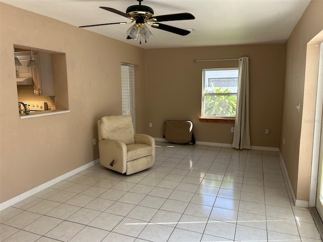 unfurnished room featuring ceiling fan and light tile patterned floors