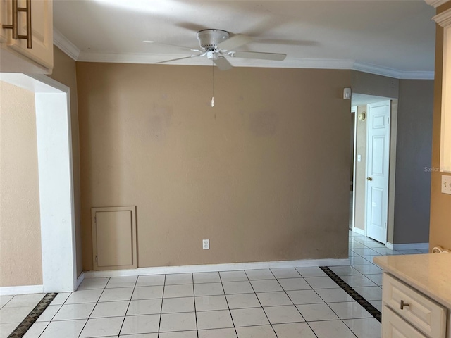 tiled spare room with ceiling fan and crown molding