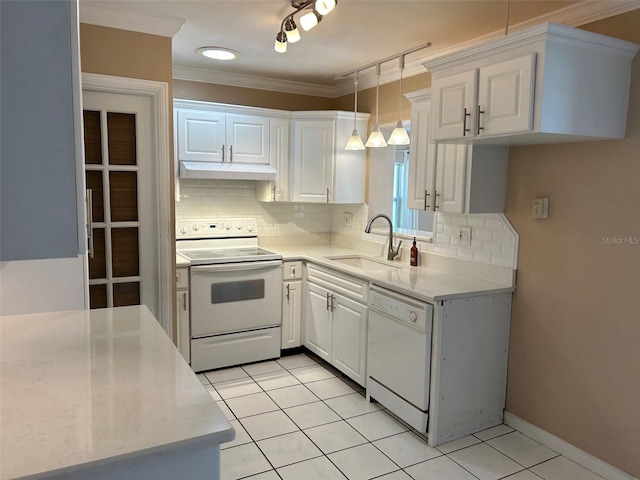 kitchen with sink, white cabinets, hanging light fixtures, and white appliances