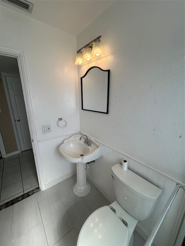 bathroom featuring sink, tile patterned flooring, and toilet