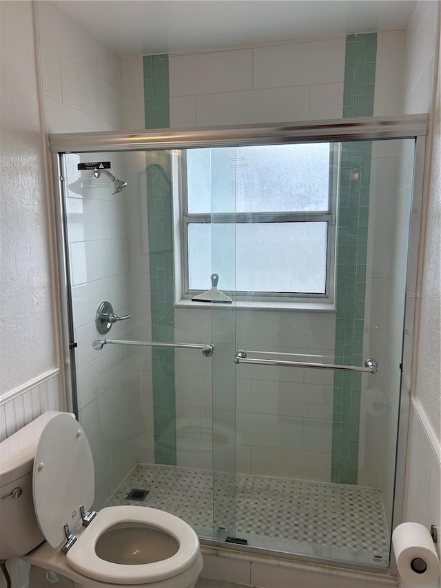 10170 64th Ave, Seminole, FL 33772 - bathroom with toilet, a stall shower, and wainscoting