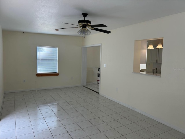 10170 64th Ave, Seminole, FL 33772 - empty room with a ceiling fan, baseboards, and light tile patterned flooring
