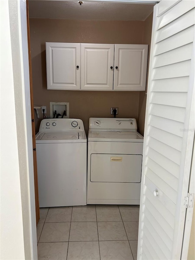 10170 64th Ave, Seminole, FL 33772 - laundry room with washer and clothes dryer, cabinet space, and light tile patterned flooring