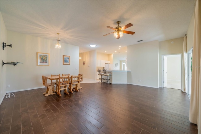 dining space featuring a textured ceiling, dark hardwood / wood-style flooring, and ceiling fan