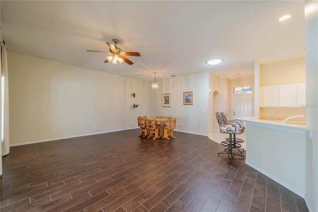 interior space featuring ceiling fan and dark wood-type flooring