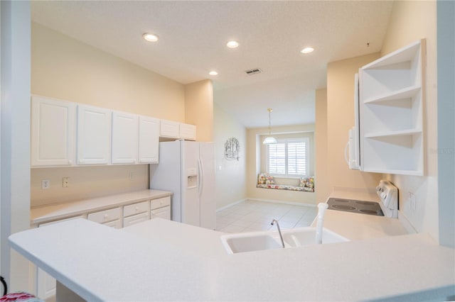 kitchen featuring kitchen peninsula, white cabinets, pendant lighting, and white appliances