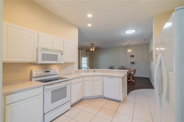 kitchen featuring white appliances, sink, kitchen peninsula, ceiling fan, and white cabinetry