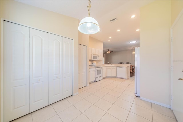 kitchen with kitchen peninsula, white appliances, ceiling fan, white cabinets, and hanging light fixtures