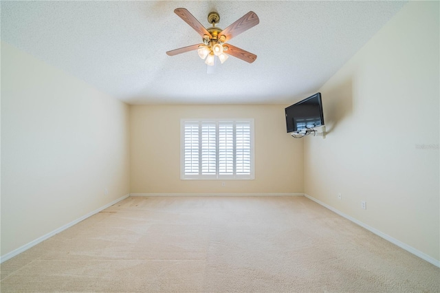 empty room with light carpet, a textured ceiling, and ceiling fan