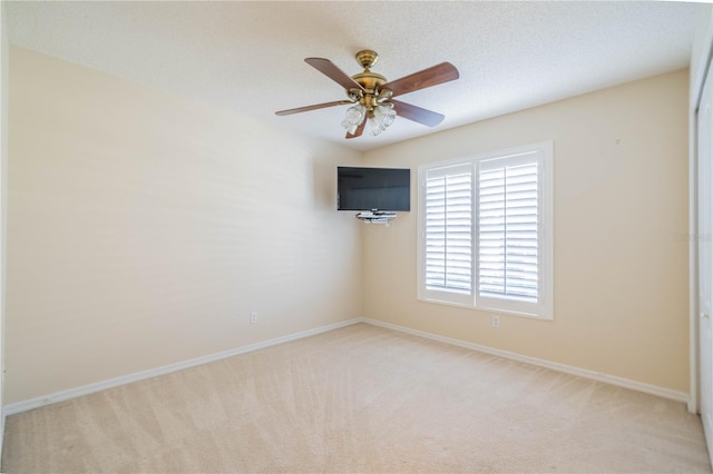 carpeted empty room with a textured ceiling and ceiling fan