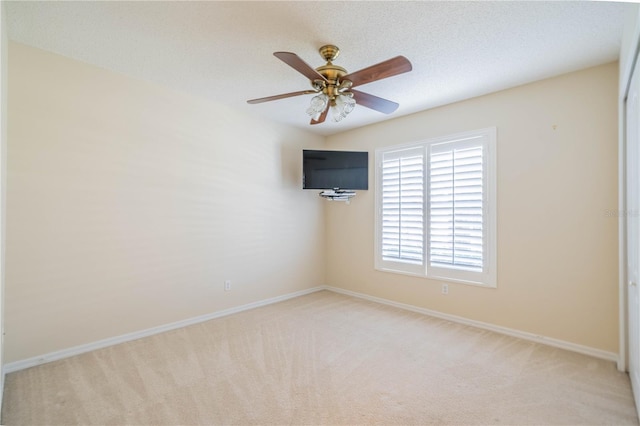 1257 Corinth Greens Dr Unit 1257, Sun City Center, FL 33573 - spare room featuring light colored carpet, ceiling fan, and baseboards