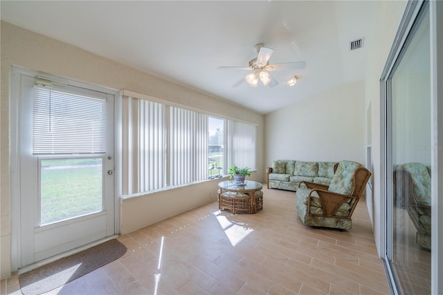 sunroom / solarium featuring vaulted ceiling, a wealth of natural light, and ceiling fan