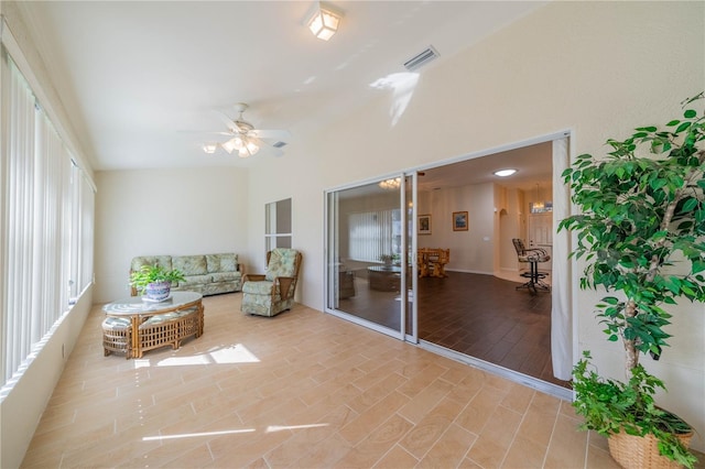 sunroom featuring ceiling fan