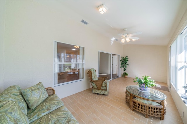 sunroom with ceiling fan and vaulted ceiling