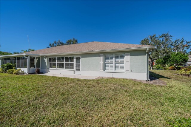 1257 Corinth Greens Dr Unit 1257, Sun City Center, FL 33573 - back of house featuring a yard, a sunroom, and stucco siding