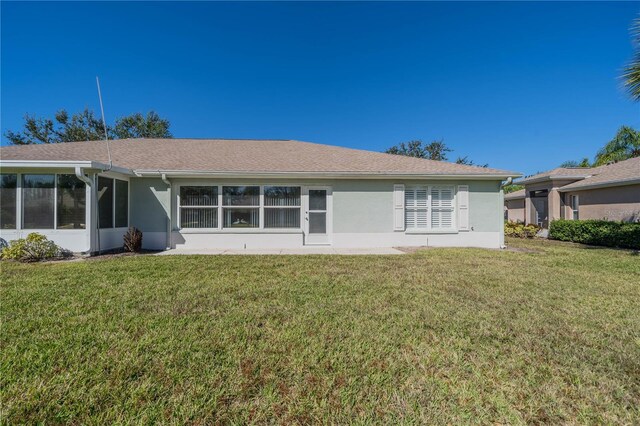 1257 Corinth Greens Dr Unit 1257, Sun City Center, FL 33573 - back of house featuring stucco siding and a lawn