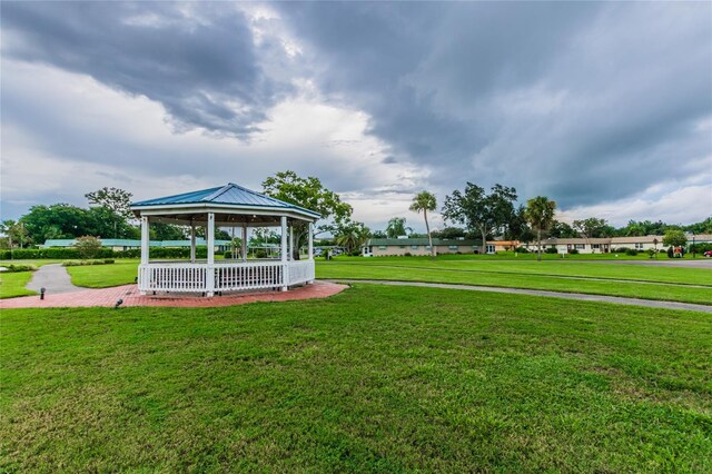 view of home's community with a lawn and a gazebo