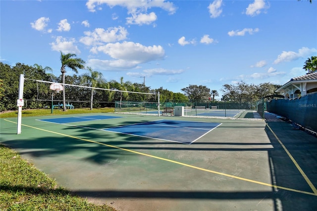 view of tennis court with basketball hoop