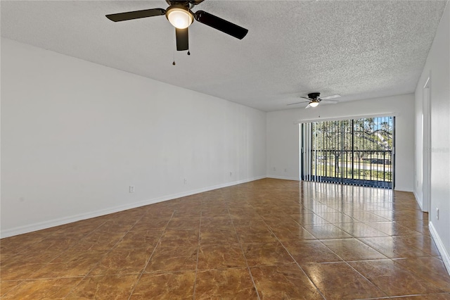 tiled empty room featuring ceiling fan and a textured ceiling