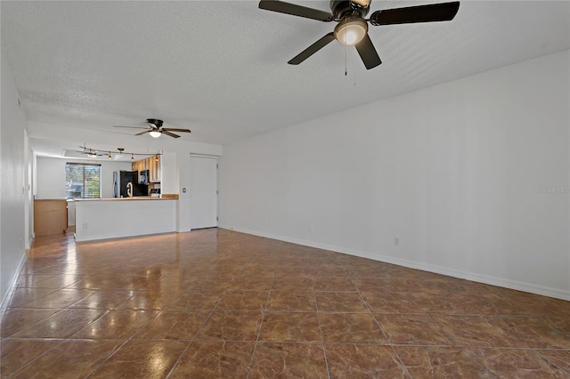 unfurnished living room featuring a textured ceiling and ceiling fan