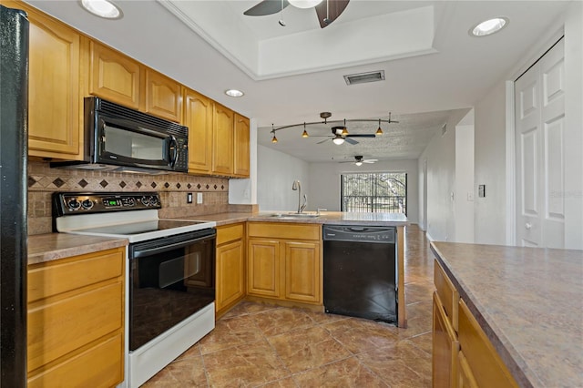 kitchen featuring black appliances, sink, ceiling fan, tasteful backsplash, and kitchen peninsula