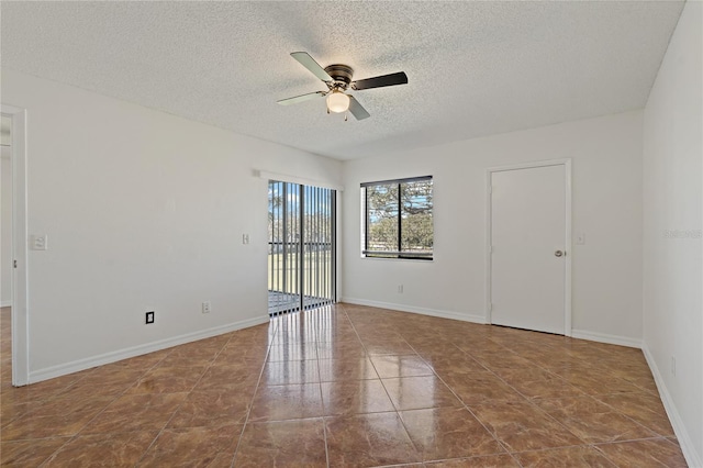 tiled spare room featuring ceiling fan and a textured ceiling