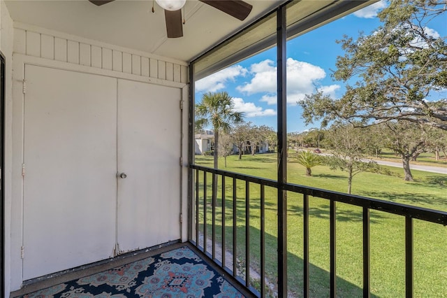 unfurnished sunroom featuring ceiling fan