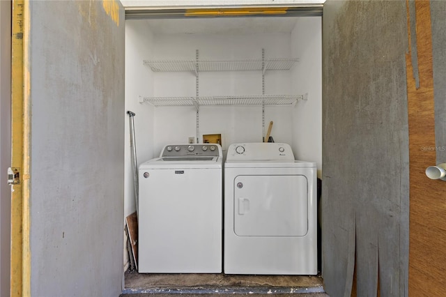 clothes washing area featuring washer and dryer