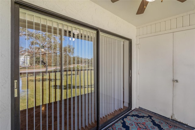 view of exterior entry featuring ceiling fan