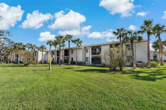 rear view of property with a yard